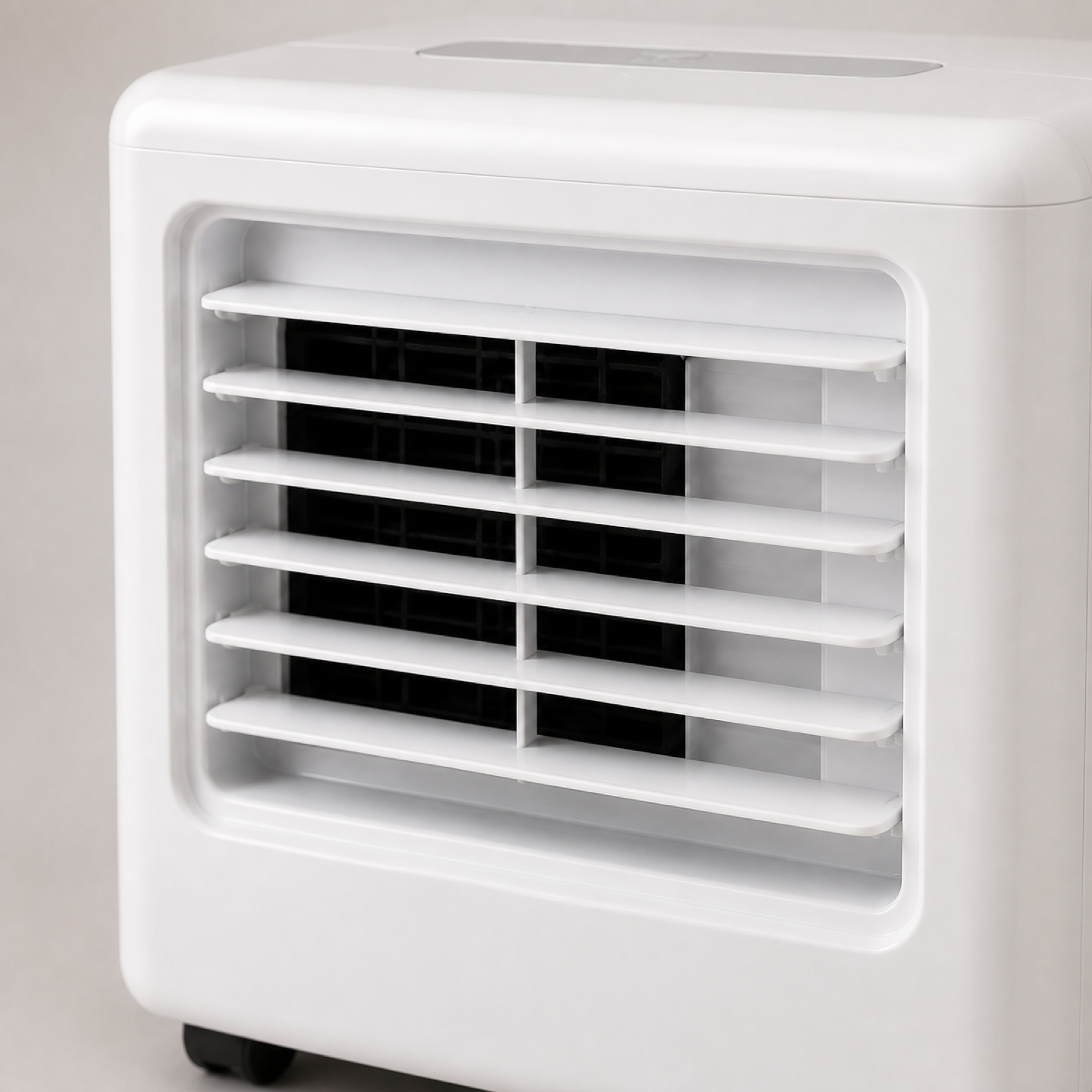 Portable air conditioner front cooling outlet with adjustable louvers